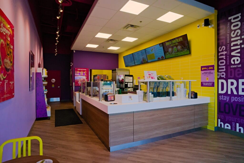 Completed interior customer ordering counter of a Booster Juice franchise renovation at Fraser Crossing in Langley.