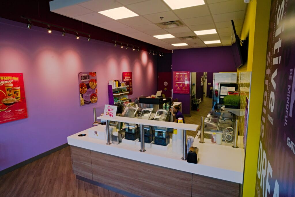Completed interior customer ordering counter of a Booster Juice franchise renovation at Fraser Crossing in Langley.