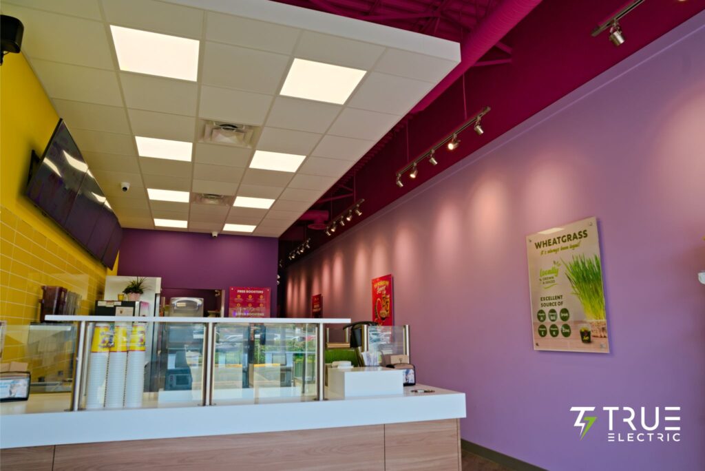 Completed modern interior ordering counter of a Booster Juice franchise renovation in Surrey
