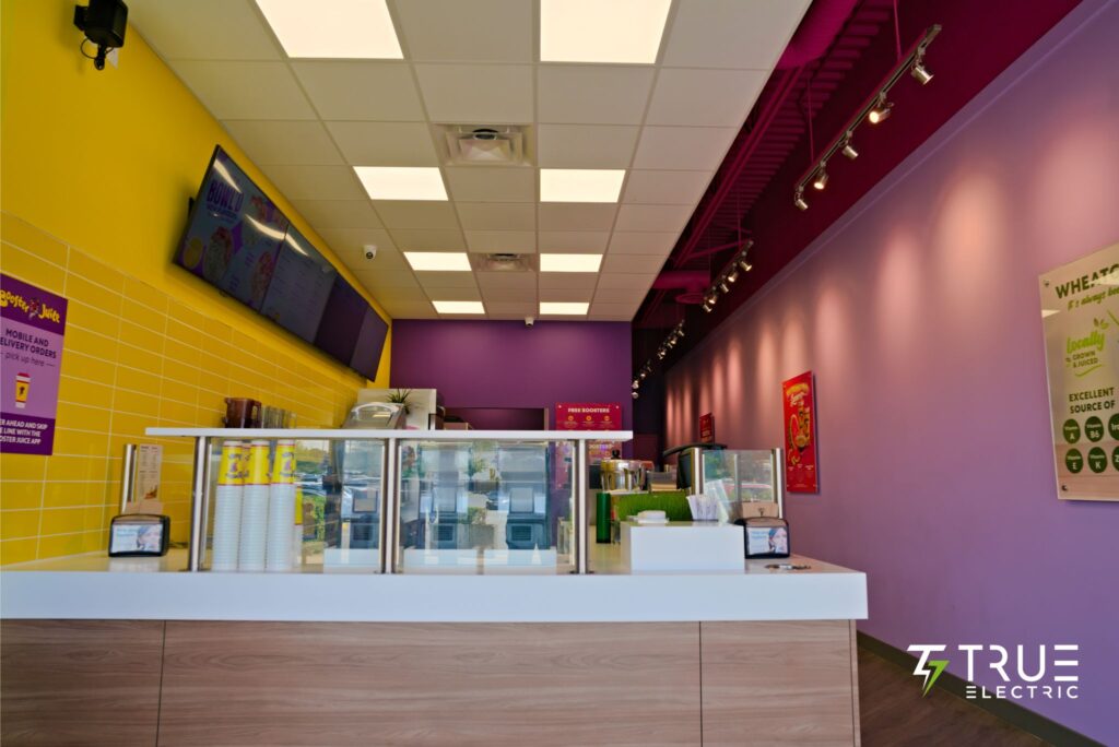 Completed modern interior ordering counter of a Booster Juice franchise renovation in Surrey