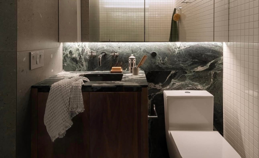High-end dark modern granite vanity with recessed architectural LED strip lighting in a Fairview Vancouver home.