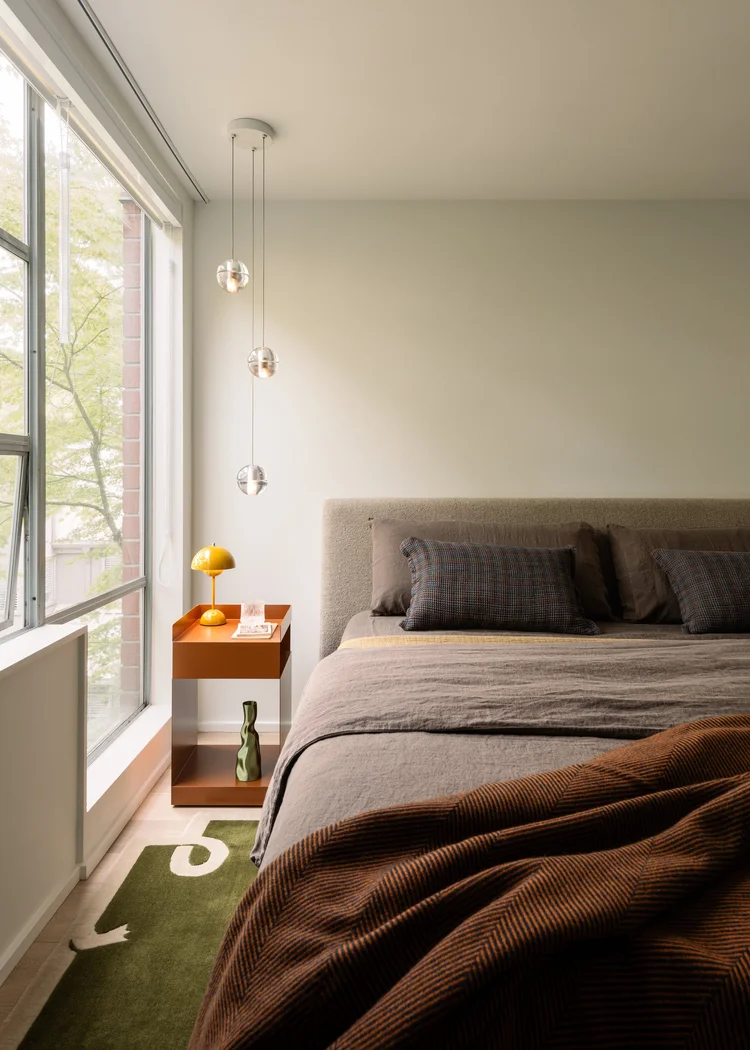 Bespoke master bedroom in a South Granville townhome featuring a high-end Bocci pendant light fixture.
