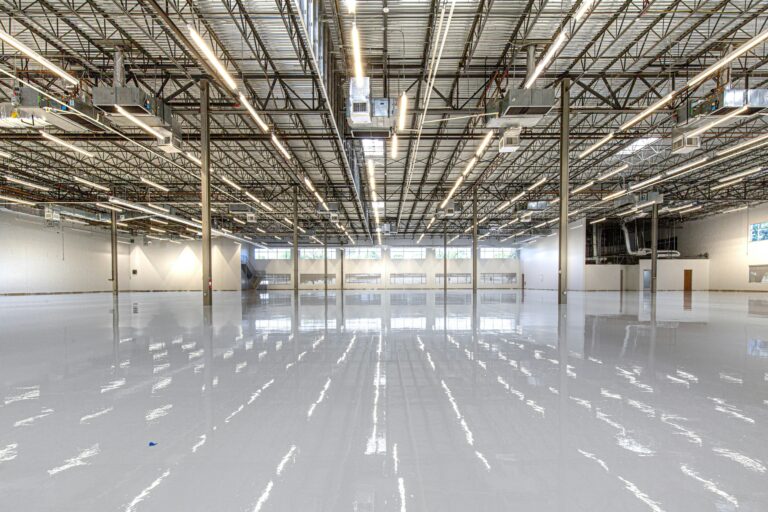 A commercial facility undergoing an energy-efficient LED lighting retrofit by a licensed technician.