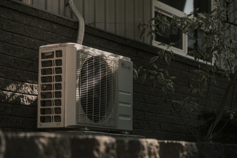 An outdoor heat pump unit completely installed and wired with a weatherproof safety disconnect switch by a licensed electrician.