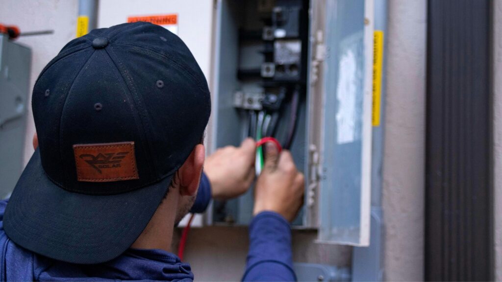 A licensed electrician performing a comprehensive electrical insurance inspection on a residential circuit breaker panel in South Surrey.