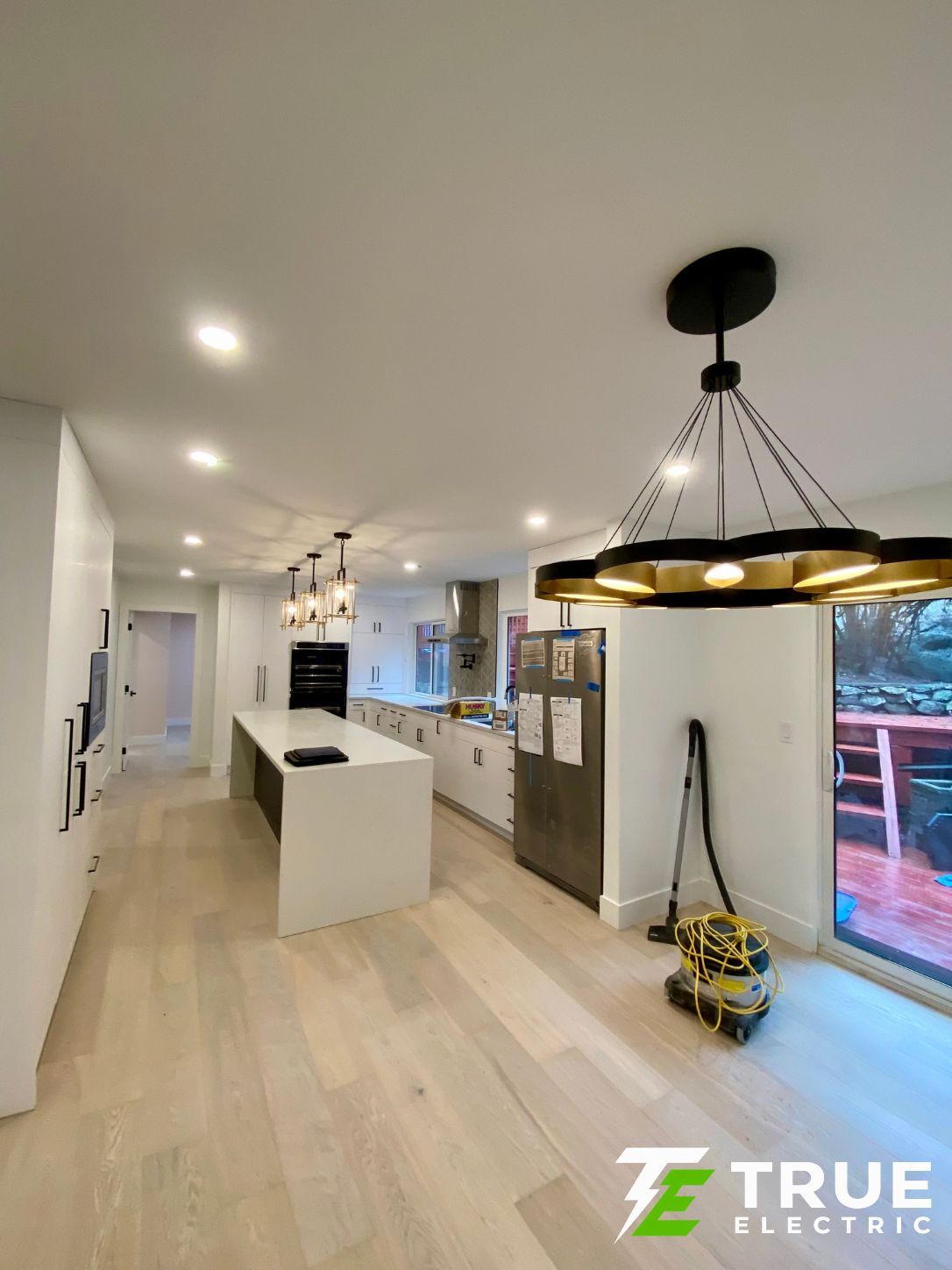 Large white quartz kitchen island with seating in a South Surrey home renovation